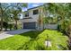 Modern two-story house with gray garage door and landscaping at 2318 Bay St, Sarasota, FL 34237