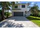 Modern two-story house with gray garage door and landscaping at 2318 Bay St, Sarasota, FL 34237