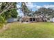 The expansive backyard offers a patio with fire pit, a storage shed and ample space for recreation at 1841 Buccaneer Dr, Sarasota, FL 34231