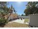 Backyard features a concrete patio with outdoor seating and a fire pit, perfect for relaxing and entertaining at 1841 Buccaneer Dr, Sarasota, FL 34231