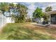 Large backyard with a well-maintained lawn, a patio area, a shed and plenty of foliage at 1841 Buccaneer Dr, Sarasota, FL 34231