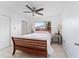 Bright bedroom with a wooden bed frame, neutral decor, and wood-look flooring, creating a serene space at 1841 Buccaneer Dr, Sarasota, FL 34231