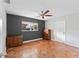 Charming bedroom with a dark accent wall, terracotta floors, and classic wood furnishings at 1841 Buccaneer Dr, Sarasota, FL 34231