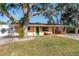 Charming single story home with green door and mature landscaping at 1841 Buccaneer Dr, Sarasota, FL 34231