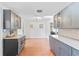 Bright kitchen featuring grey cabinetry, expansive countertops, and unique tiled flooring at 1841 Buccaneer Dr, Sarasota, FL 34231
