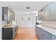 Modern kitchen features gray cabinetry, quartz countertops, and terracotta tile floors at 1841 Buccaneer Dr, Sarasota, FL 34231