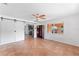 Open living room with unique terracotta-tiled floors, a modern ceiling fan, and sliding barn doors at 1841 Buccaneer Dr, Sarasota, FL 34231