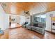 Cozy living room with a wood-paneled ceiling, comfortable seating, and terracotta-tiled floors at 1841 Buccaneer Dr, Sarasota, FL 34231