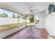 Relaxing screened porch with tiled floor and ceiling fan at 1841 Buccaneer Dr, Sarasota, FL 34231