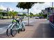 Charming street view featuring a blue bicycle parked beside a tree and sidewalk shops in the background at 1841 Buccaneer Dr, Sarasota, FL 34231