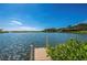 Beautiful waterfront view with a private dock on a sunny day, perfect for boating and relaxation at 1841 Buccaneer Dr, Sarasota, FL 34231