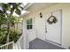 Front entrance with a welcoming wreath and gray deck at 5214 Winding Way, Sarasota, FL 34242