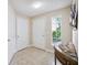 Inviting entryway with neutral tones, decorative seashell accents, and a tiled floor at 5552 Bentgrass Dr # 7-101, Sarasota, FL 34235