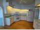 Bright kitchen features white cabinets, stainless appliances, and hardwood floors at 80 Cabello St, Punta Gorda, FL 33983