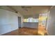 Open-concept living space with hardwood floors connected to the kitchen at 80 Cabello St, Punta Gorda, FL 33983