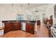 Open kitchen with island, granite counters, stainless steel appliances, and breakfast nook at 7341 Featherstone Blvd, Sarasota, FL 34238