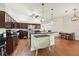 Spacious kitchen with dark wood cabinets, granite counters, and stainless steel appliances at 7341 Featherstone Blvd, Sarasota, FL 34238