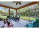 Spacious screened porch with seating and lush landscaping at 7341 Featherstone Blvd, Sarasota, FL 34238