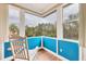 Bright sunroom with rocking chair, and expansive views at 7341 Featherstone Blvd, Sarasota, FL 34238