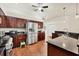 Kitchen boasts dark wood cabinets, granite countertops, and stainless steel appliances at 7341 Featherstone Blvd, Sarasota, FL 34238