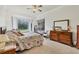 Bright bedroom with floral bedding, dresser, and garden view at 7341 Featherstone Blvd, Sarasota, FL 34238