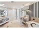 Large bathroom with double vanities and a soaking tub at 8213 Midnight Pass Rd, Sarasota, FL 34242