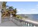 Balcony overlooking the water with stone balustrades at 8213 Midnight Pass Rd, Sarasota, FL 34242