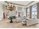Grand living room with high ceilings, chandelier, and water views at 8213 Midnight Pass Rd, Sarasota, FL 34242