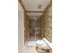 Bathroom with shower and toilet, featuring bird wallpaper at 8213 Midnight Pass Rd, Sarasota, FL 34242