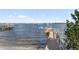 Wooden walkway leads to private boat dock on calm water at 8213 Midnight Pass Rd, Sarasota, FL 34242