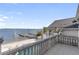 Balcony with water views and stone balustrades at 8213 Midnight Pass Rd, Sarasota, FL 34242