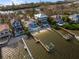 Wide aerial showing waterfront homes, private beach access, and boat docks at 8213 Midnight Pass Rd, Sarasota, FL 34242