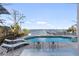 Relaxing pool area with patio furniture and water views at 8213 Midnight Pass Rd, Sarasota, FL 34242