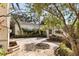 Stone courtyard with lush landscaping and fountain at 8213 Midnight Pass Rd, Sarasota, FL 34242