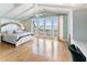 Bright bedroom with water views and a white wooden bed frame at 8213 Midnight Pass Rd, Sarasota, FL 34242