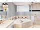 Bathroom with corner soaking tub and glass-enclosed shower at 8213 Midnight Pass Rd, Sarasota, FL 34242