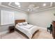 Bright bedroom with wood headboard and plantation shutters at 8213 Midnight Pass Rd, Sarasota, FL 34242