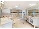 Spa-like bathroom with a soaking tub, walk-in shower, and striped wallpaper at 8213 Midnight Pass Rd, Sarasota, FL 34242