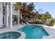 Resort-style pool and spa with lounge chairs at 8213 Midnight Pass Rd, Sarasota, FL 34242