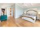 Spacious bedroom with hardwood floors and access to the bathroom at 8213 Midnight Pass Rd, Sarasota, FL 34242