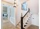 Elegant staircase with a wrought iron railing and a view into another room at 8213 Midnight Pass Rd, Sarasota, FL 34242