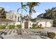 Elegant home exterior with gated entry and lush landscaping at 8213 Midnight Pass Rd, Sarasota, FL 34242