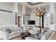 Living room with high ceilings, chandelier, and water views at 8213 Midnight Pass Rd, Sarasota, FL 34242