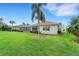 Expansive grassy backyard with home view at 1210 Eagles Flight Way, North Port, FL 34287