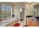 Bathroom with oval soaking tub and separate shower at 1210 Eagles Flight Way, North Port, FL 34287