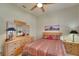 Bright bedroom with a double bed, wood furniture, and large mirror at 1210 Eagles Flight Way, North Port, FL 34287