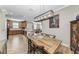 Open dining room with a farmhouse table and kitchen views at 5016 Savona Run, Bradenton, FL 34211