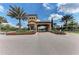 Gated community entrance with palm trees and landscaping at 5016 Savona Run, Bradenton, FL 34211