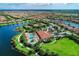 Aerial view of community with pool, clubhouse, and tennis courts at 5016 Savona Run, Bradenton, FL 34211