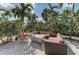 Relaxing outdoor fire pit area with comfortable seating surrounded by lush tropical landscaping at 5016 Savona Run, Bradenton, FL 34211